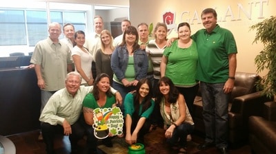 Group staff photo with each employee wearing green
