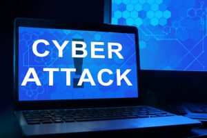 Computer with words cyber attack