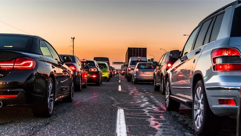 Cars stuck in a traffic jam at sunset
